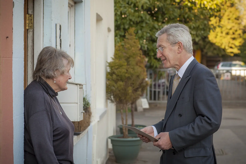 George Fussey talks to local resident